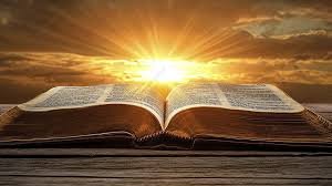 download (1) uma Bíblia aberta sobre uma mesa iluminada pela luz suave da manhã.