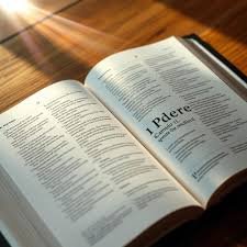 download (11) Bíblia aberta no livro de 1 Pedro com luz suave simbolizando esperança em meio às provações.
