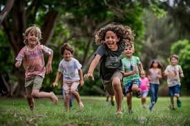 download (51) criança rindo enquanto brinca ao ar livre com um adulto, transmitindo leveza e conexão